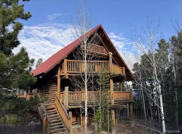 a front view of house along with deck and outdoor seating