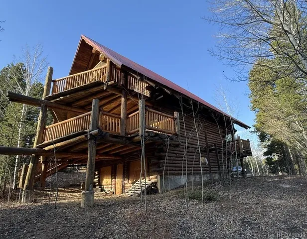 a view of a house with a window and wooden fence
