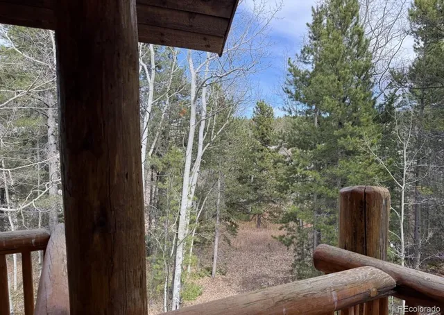 a view of a porch with a table and chairs