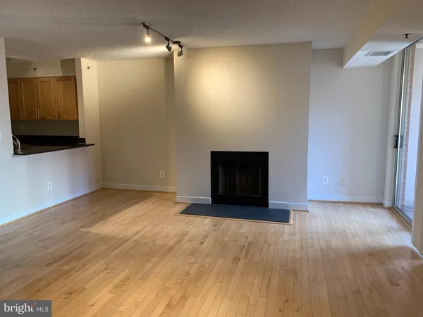 a view of an empty room with a fireplace