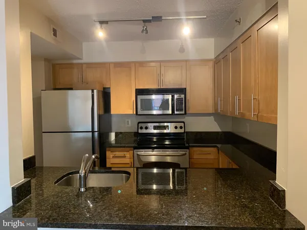 a kitchen with a refrigerator and a sink