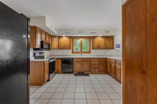 a kitchen with stainless steel appliances granite countertop a refrigerator and sink