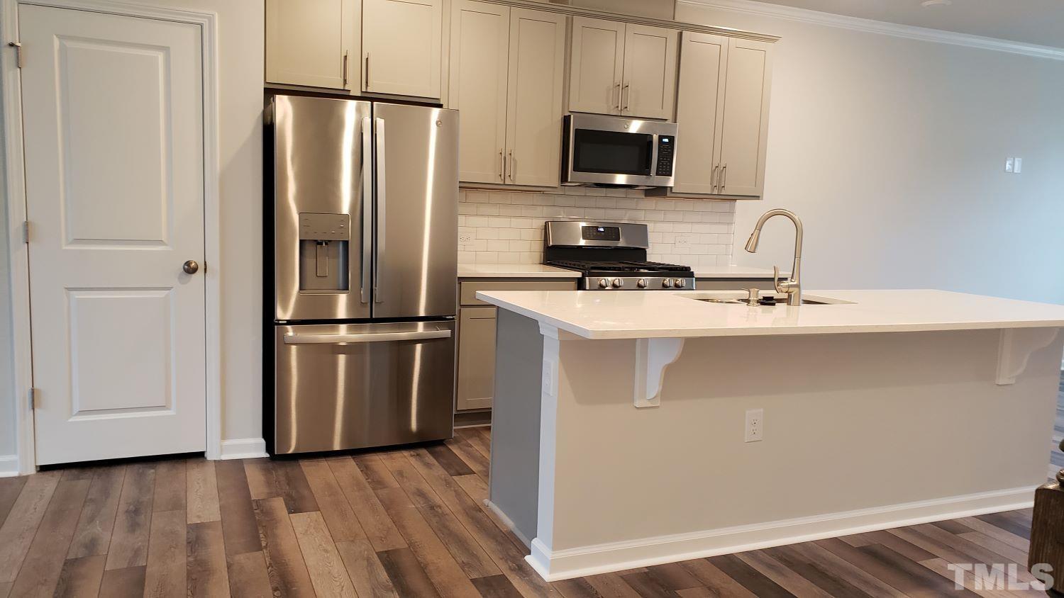 1833 Joscara Lane, Unit 1833 Apex, NC 27502 - Photo 11 of 37 a kitchen with wooden cabinets and stainless steel appliances