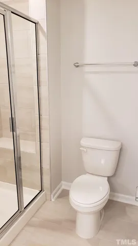 a white toilet sitting next to a bath tub