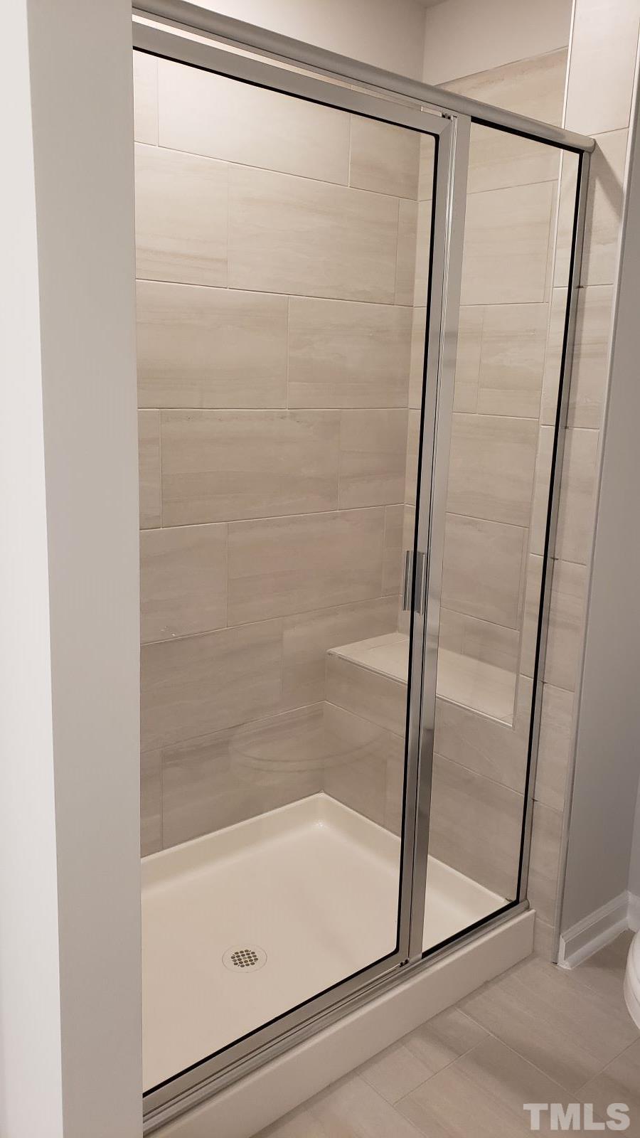 1833 Joscara Lane, Unit 1833 Apex, NC 27502 - Photo 25 of 37 a bathroom with a glass shower door