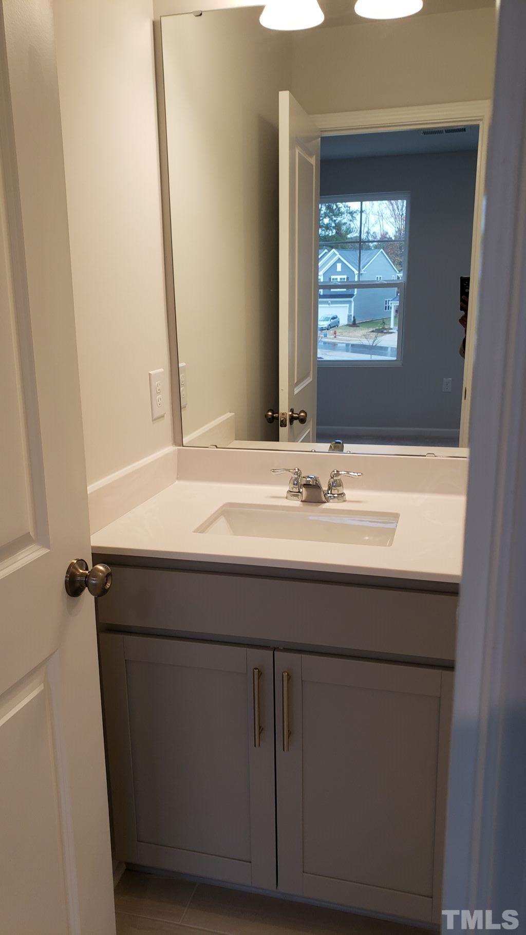 1833 Joscara Lane, Unit 1833 Apex, NC 27502 - Photo 26 of 37 a bathroom with a sink and a mirror