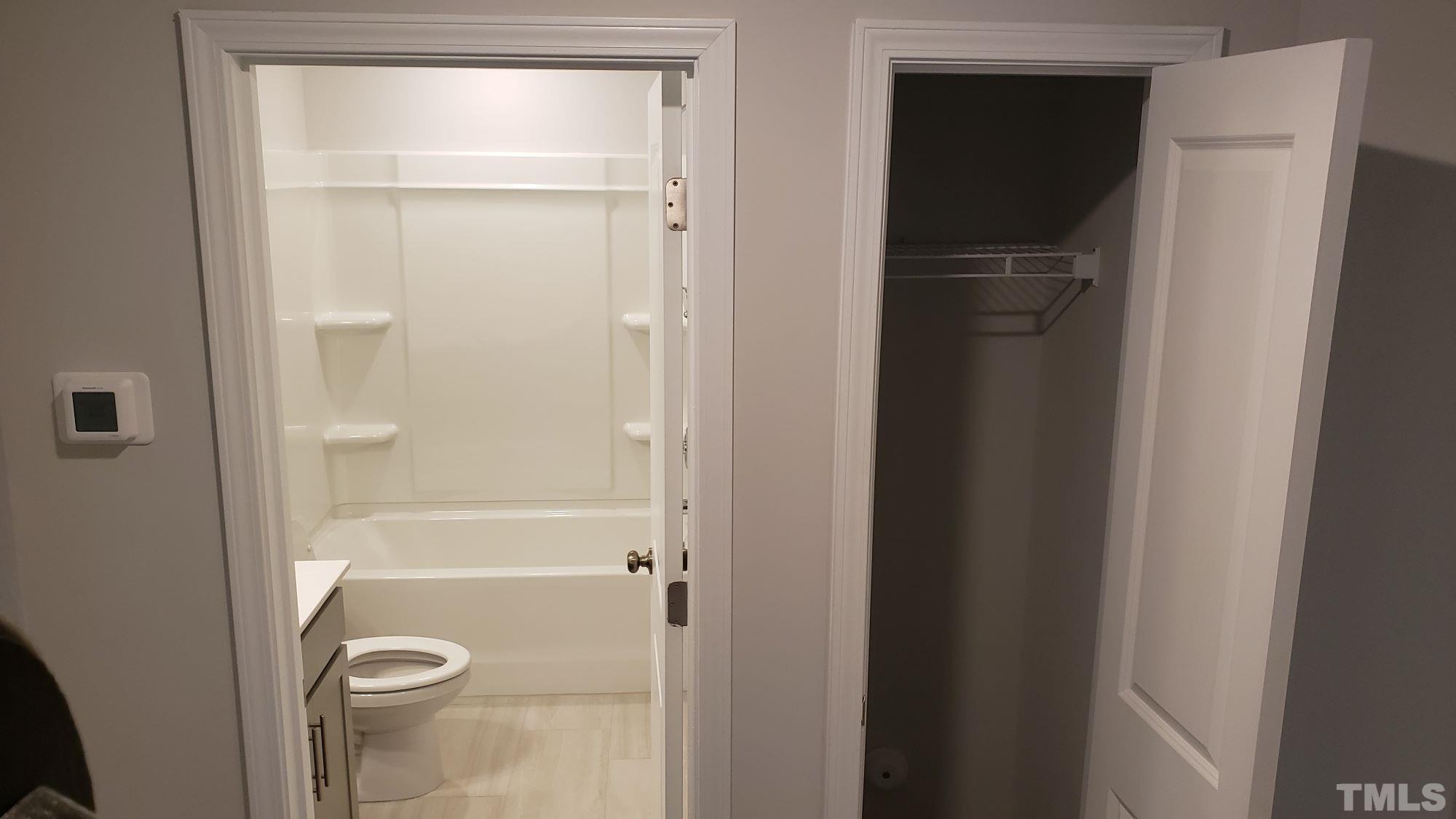 1833 Joscara Lane, Unit 1833 Apex, NC 27502 - Photo 27 of 37 a bathroom with a glass shower door