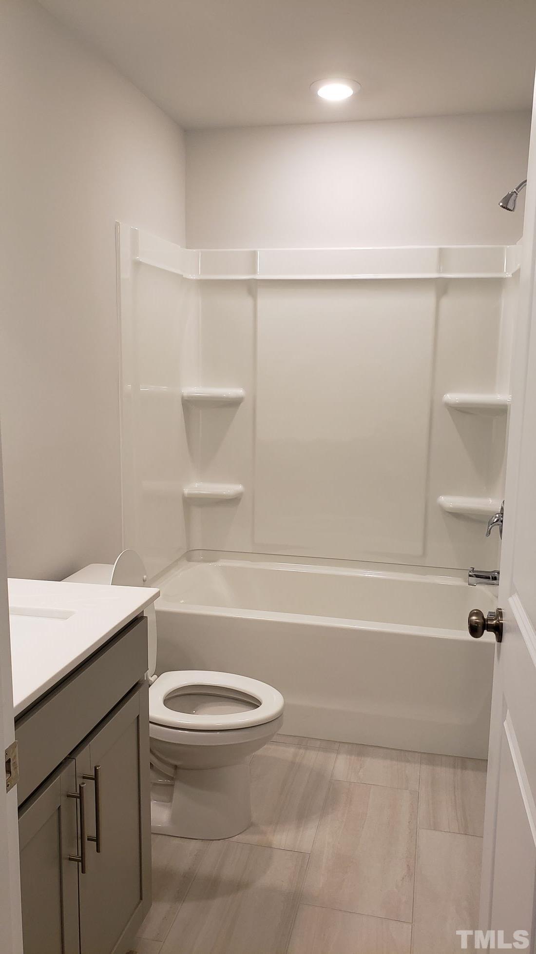 1833 Joscara Lane, Unit 1833 Apex, NC 27502 - Photo 29 of 37 a bathroom with a toilet and a bathtub