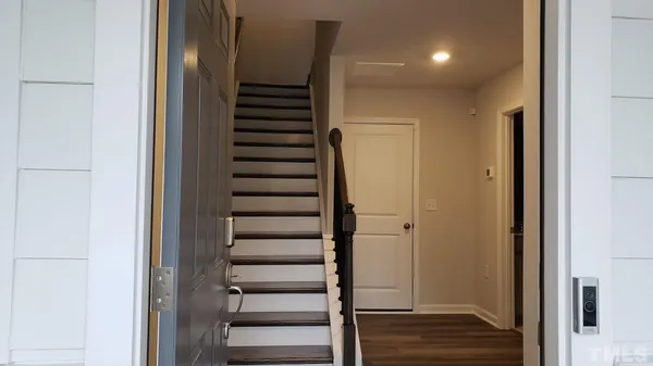 a view of walk in closet with wooden floor