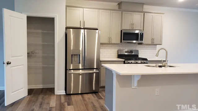a kitchen with wooden cabinets and stainless steel appliances