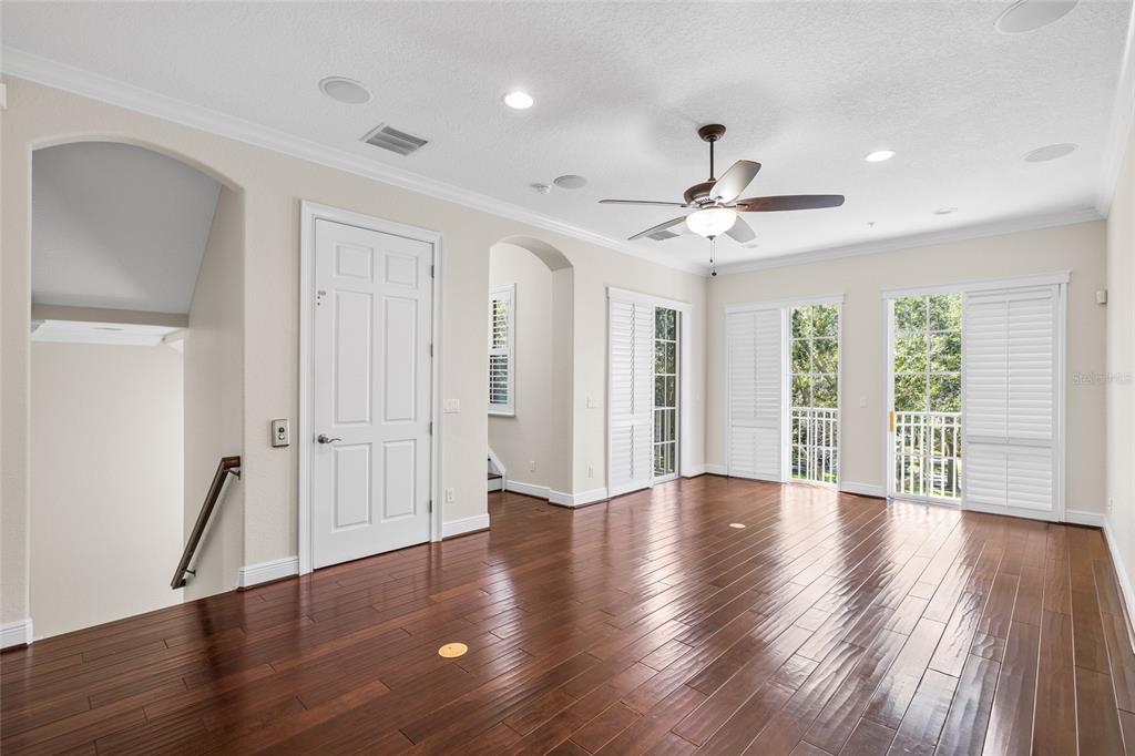 6002 Printery Street, Unit 105 Tampa, FL 33616 - Photo 11 of 64 a view of an empty room with wooden floor and a window