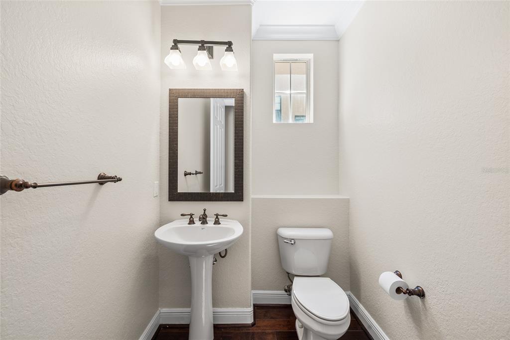 6002 Printery Street, Unit 105 Tampa, FL 33616 - Photo 17 of 64 a bathroom with a toilet a sink and a mirror