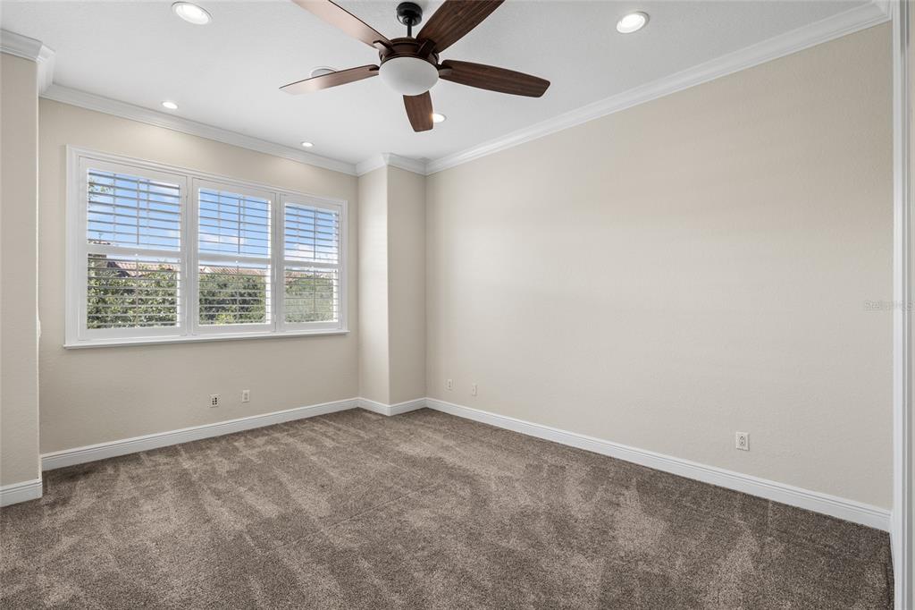6002 Printery Street, Unit 105 Tampa, FL 33616 - Photo 25 of 64 an empty room with a window and a ceiling fan