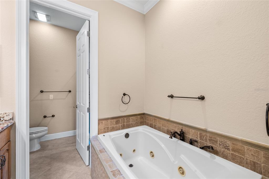 6002 Printery Street, Unit 105 Tampa, FL 33616 - Photo 29 of 64 a bathroom with a bathtub and a toilet