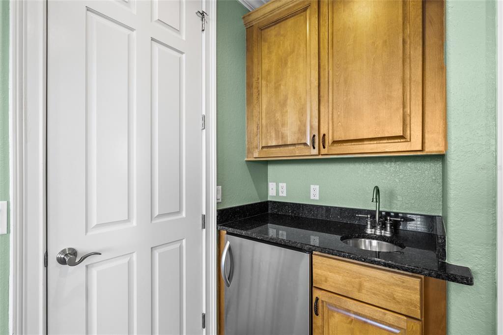 6002 Printery Street, Unit 105 Tampa, FL 33616 - Photo 37 of 64 a kitchen with granite countertop white cabinets and sink