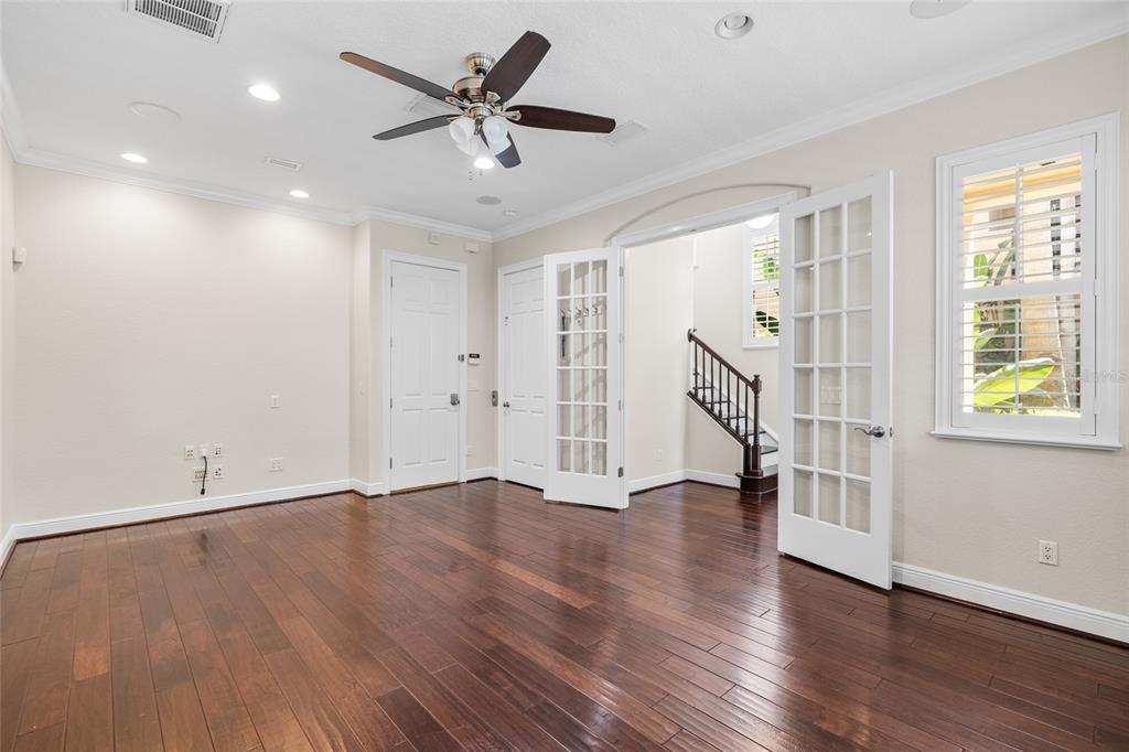 6002 Printery Street, Unit 105 Tampa, FL 33616 - Photo 6 of 64 a view of an empty room with wooden floor and a window