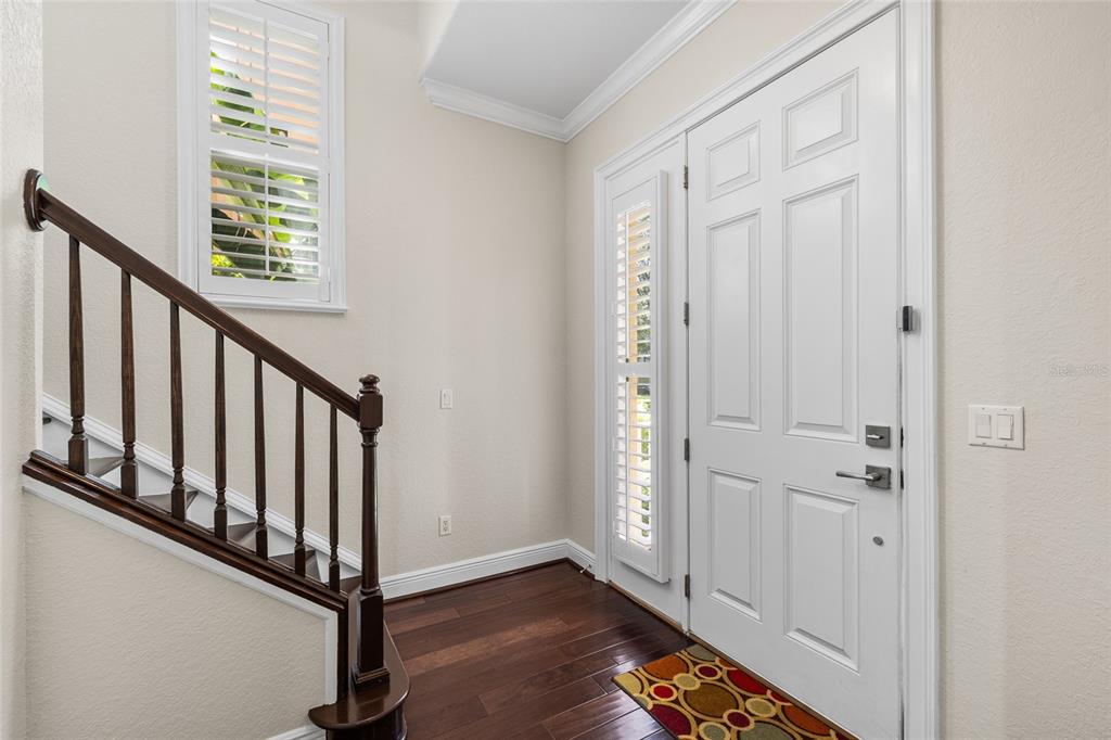 6002 Printery Street, Unit 105 Tampa, FL 33616 - Photo 7 of 64 a view of an entryway with wooden floor
