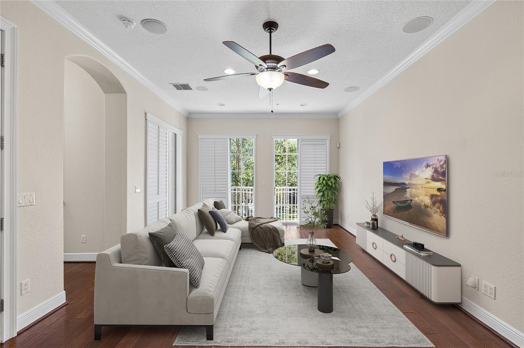 6002 Printery Street, Unit 105 Tampa, FL 33616 - Photo 8 of 64 a living room with furniture and a flat screen tv