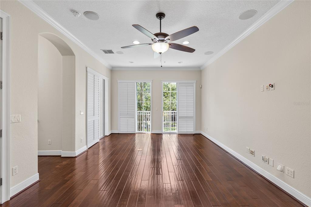 6002 Printery Street, Unit 105 Tampa, FL 33616 - Photo 9 of 64 wooden floor in an empty room with a window