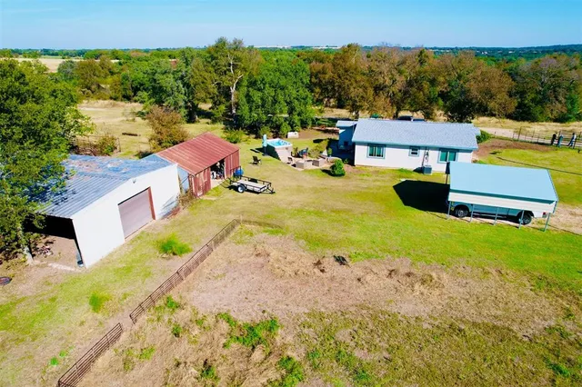 a view of a house with pool and sitting area