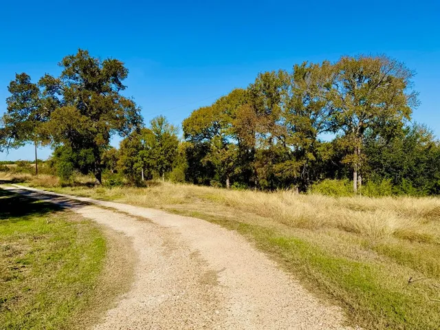 a backyard of a house with a table and chairs
