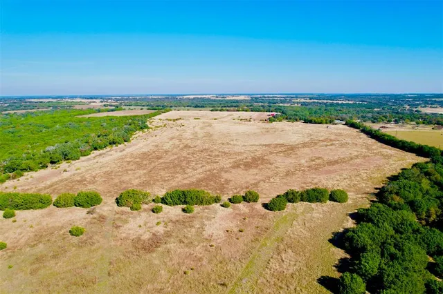 a view of a lake with beach and city view