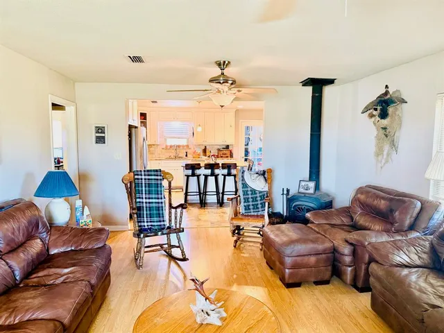 a kitchen with granite countertop a refrigerator and a stove top oven