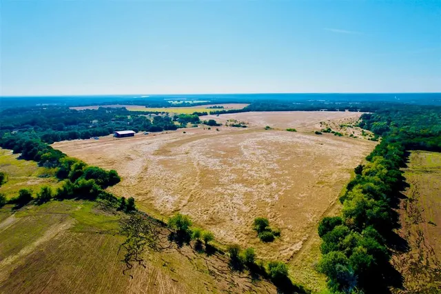 an aerial view of beach and residential houses with outdoor space