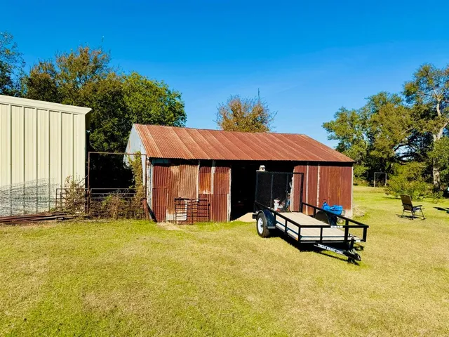 a view of backyard of house with outdoor seating