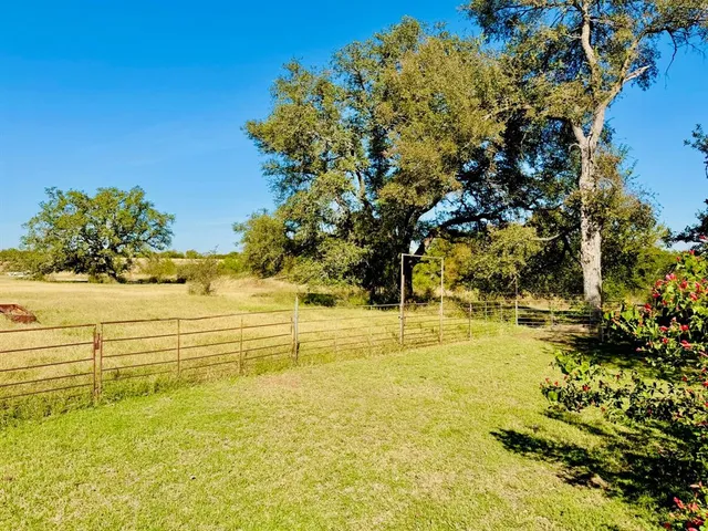 a view of a chairs and table in patio