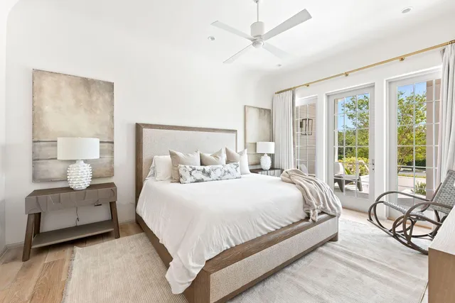 a bedroom with a bed and a large window