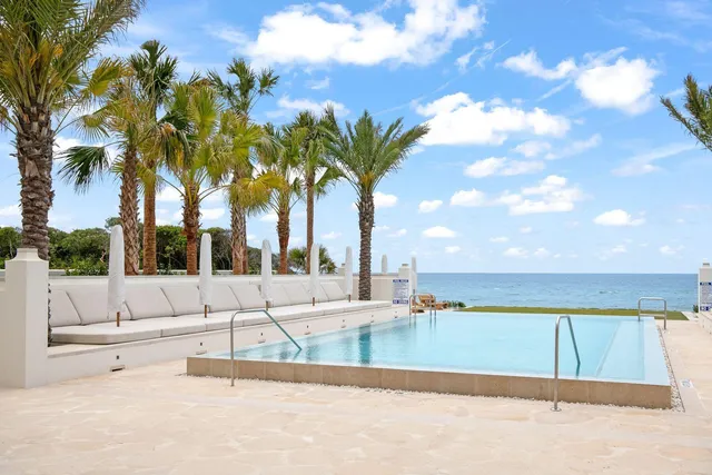 a view of swimming pool with an outdoor seating