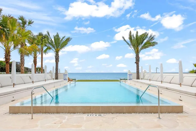 a view of a swimming pool with a lounge chairs
