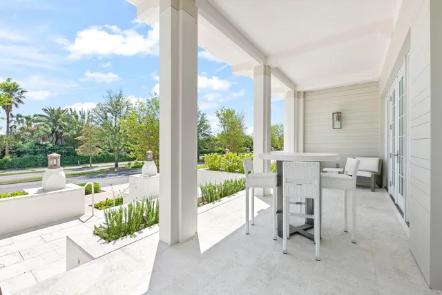 a view of a porch with furniture and garden