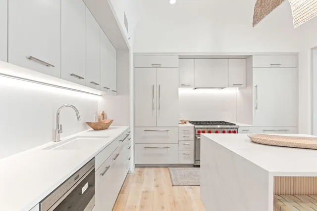 a kitchen with stainless steel appliances granite countertop a sink and a stove top oven