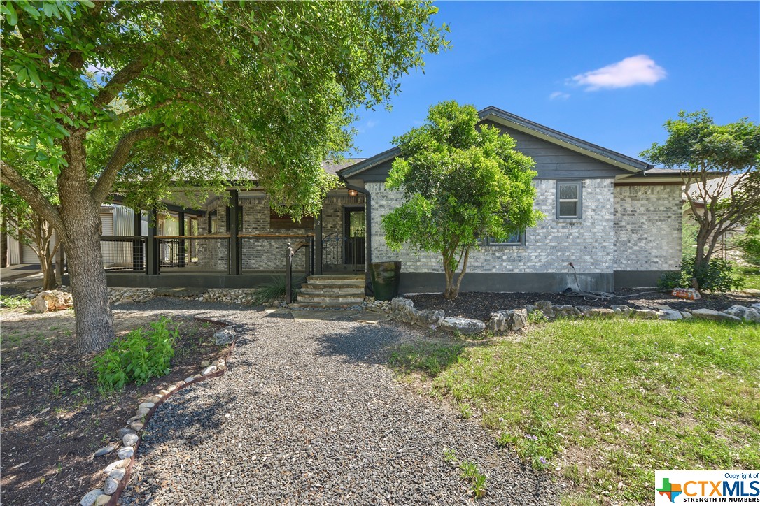 72 Saddle Rock Ridge Street Wimberley, TX 78676 - Photo 1 of 1 a front view of a house with garden