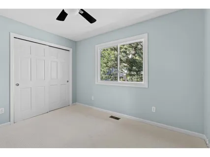 a bathroom with a shower a toilet and a window