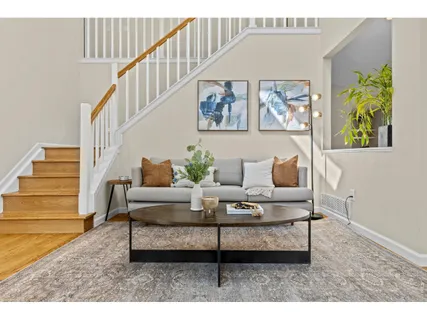 a living room with furniture and a painting