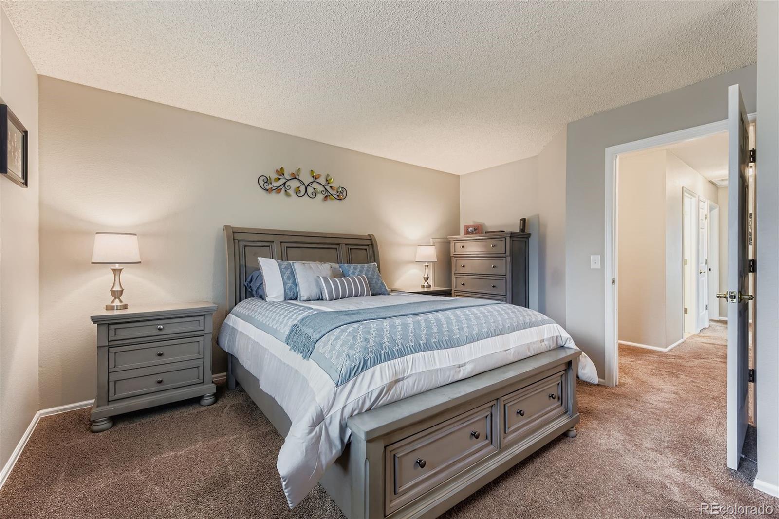 1055 Northridge Road Highlands Ranch, CO 80126 - Photo 16 of 32 a bedroom with a bed and a dresser