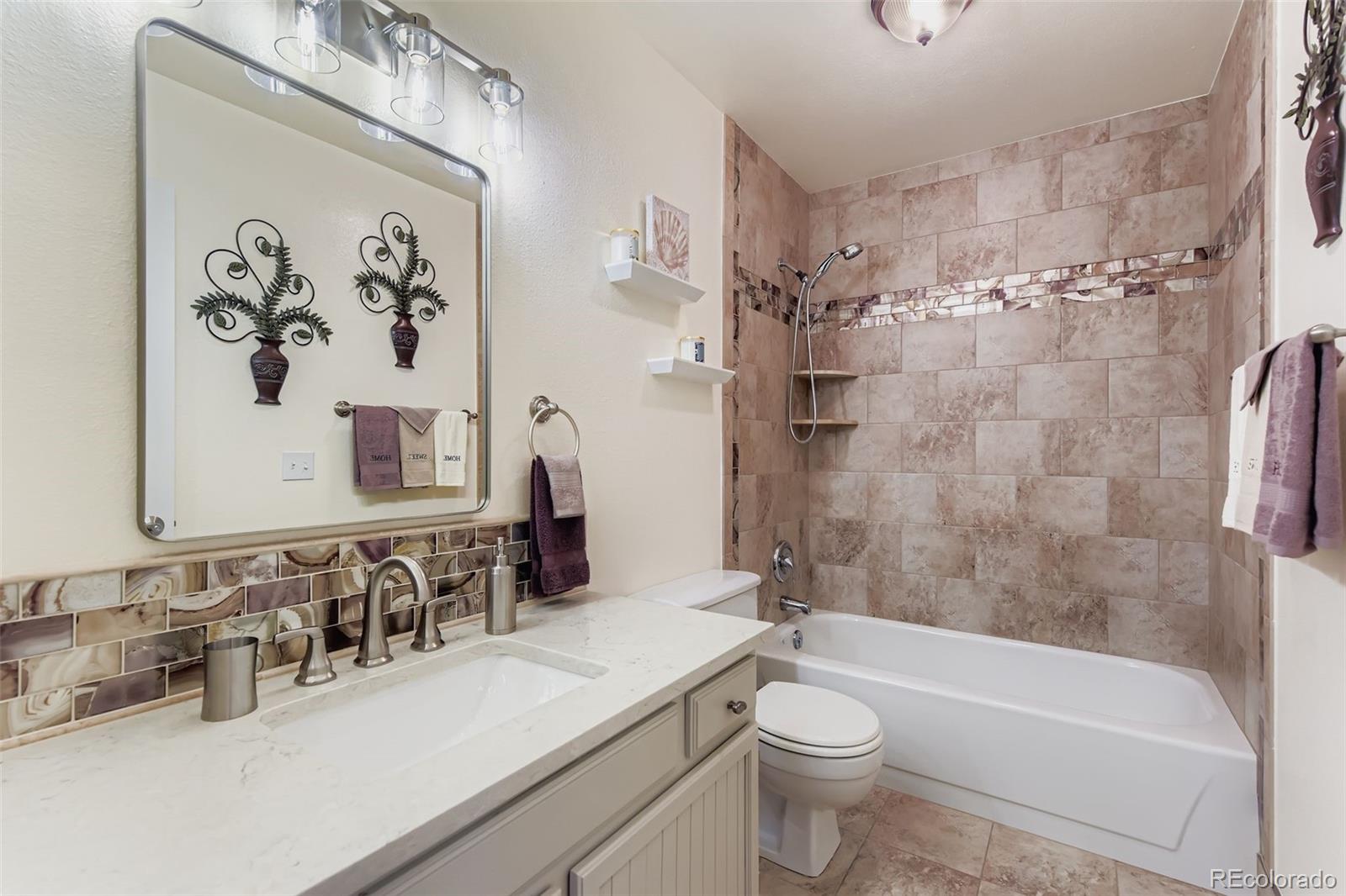 1055 Northridge Road Highlands Ranch, CO 80126 - Photo 23 of 32 a bathroom with a sink a toilet and shower