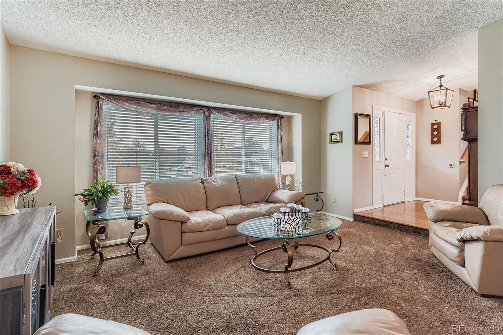 1055 Northridge Road Highlands Ranch, CO 80126 - Photo 6 of 32 a living room with furniture and a large window