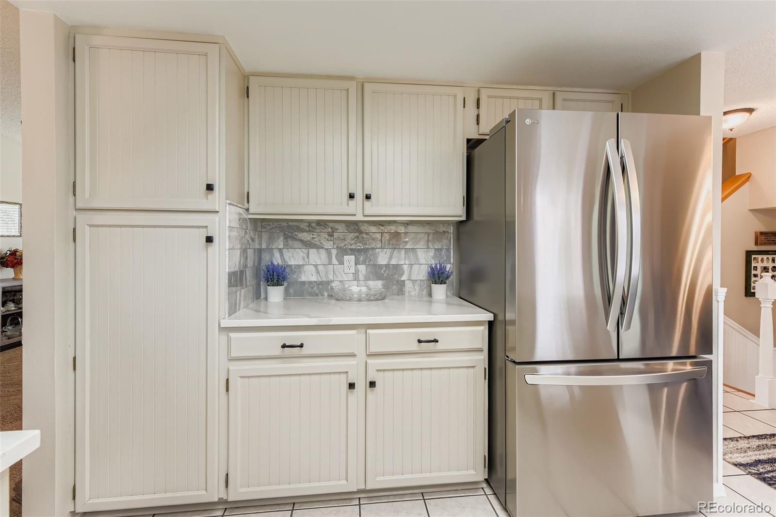 1055 Northridge Road Highlands Ranch, CO 80126 - Photo 9 of 32 a kitchen with a refrigerator sink and cabinets