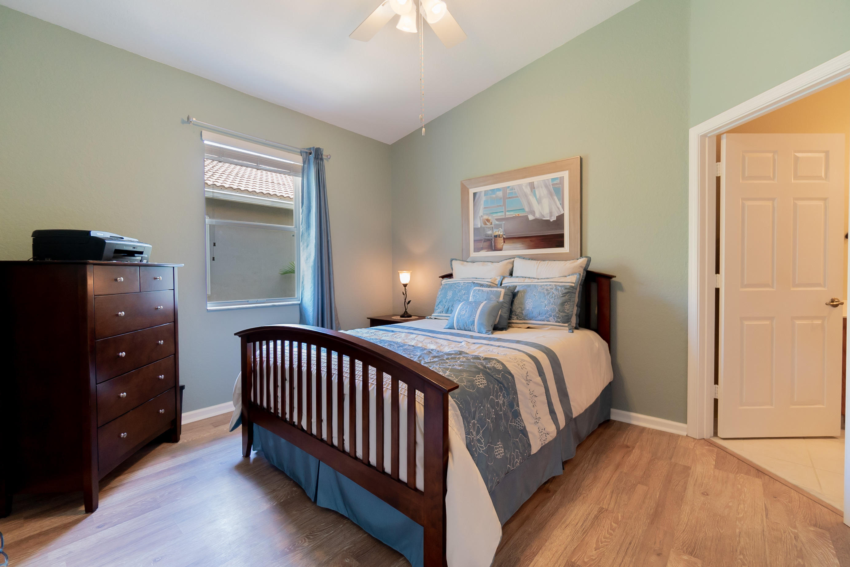 3170 Laurel Ridge Circle Riviera Beach, FL 33404 - Photo 17 of 27 a bedroom with a bed and a window