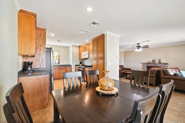 a kitchen with a stove a microwave and dining table