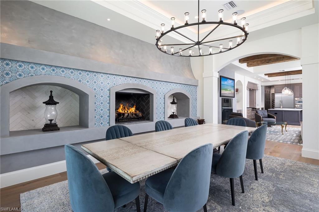 Undisclosed Address Naples, FL 34108 - Photo 11 of 16 a view of a dining room with furniture and a chandelier