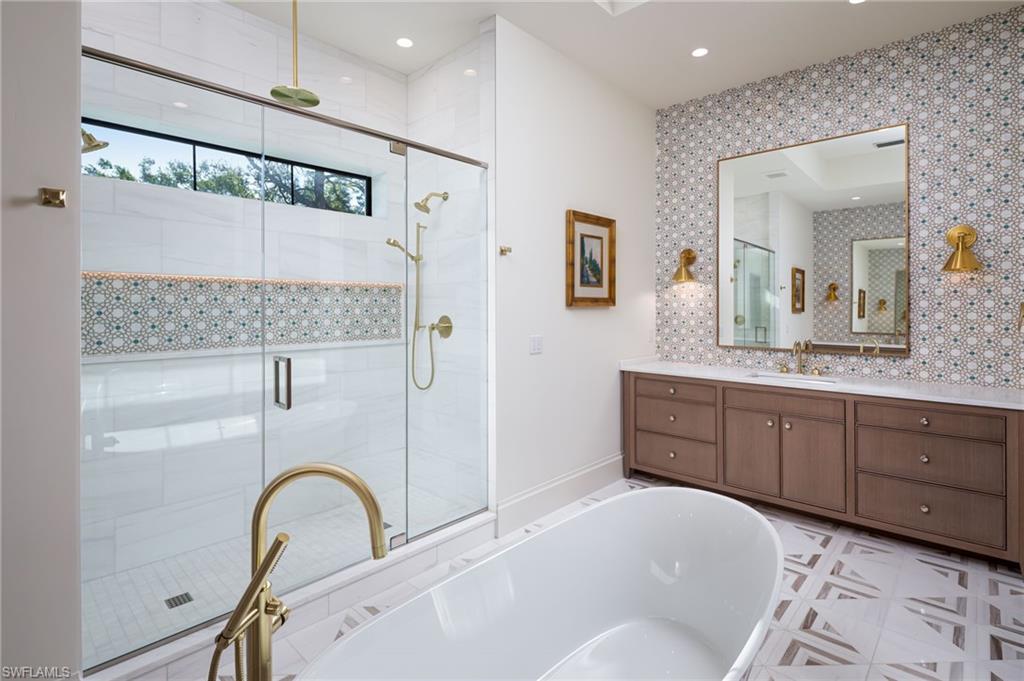 Undisclosed Address Naples, FL 34108 - Photo 14 of 16 a spacious bathroom with a sink and a mirror