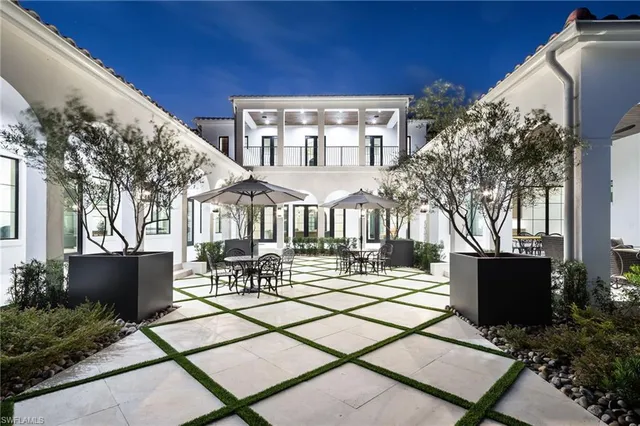 a view of a patio with table and chairs and potted plants