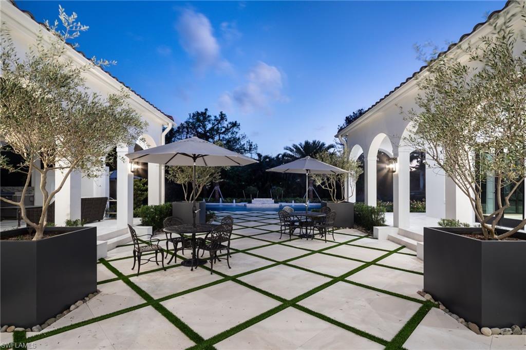 Undisclosed Address Naples, FL 34108 - Photo 4 of 16 a view of outdoor kitchen and dining room