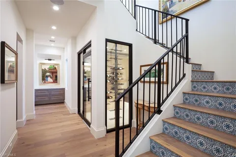 a view of staircase with lots of frames and a rug
