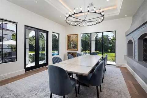 a view of a dining room with furniture large windows and wooden floor